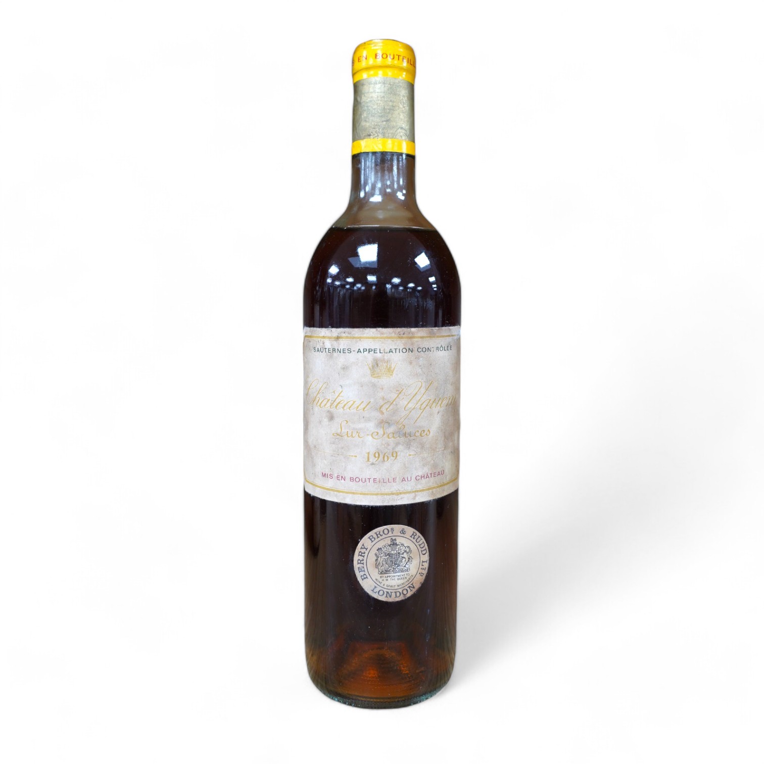 A bottle of Chateau d'Yquem, 1969. Condition - fair, level just above mid shoulder, label poor